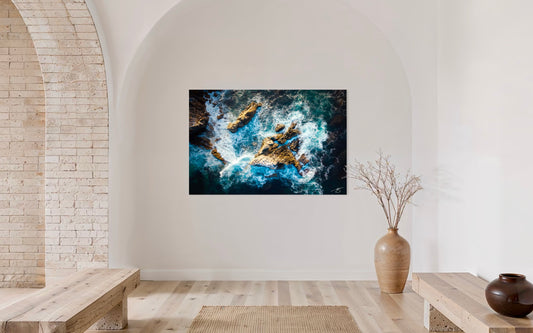 Abstract artwork on a wall in a modern interior setting with wooden benches and a vase.