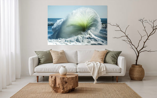 Living room with a large wall art of a wave, white sofa with pillows, wooden coffee table, and decorative plant.