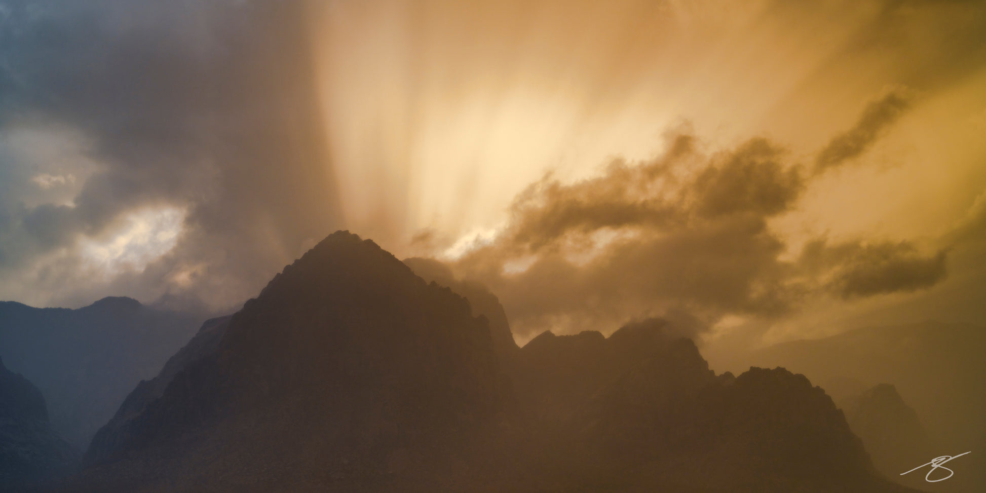 Golden rays over desert mountains after storm – fine-art landscape by Beau Jesse Johnston.