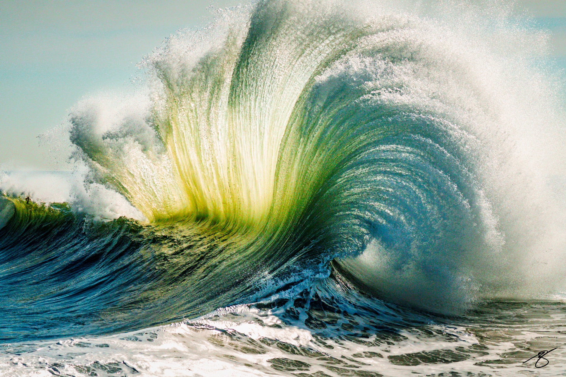 Backlit ocean wave exploding into a glowing emerald fan of spray with a curling barrel and textured water; dramatic coastal fine art photograph