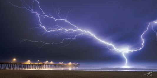 Powerful lightning bolts over Pismo Beach Pier captured in a dramatic fine art photograph of nature’s raw energy