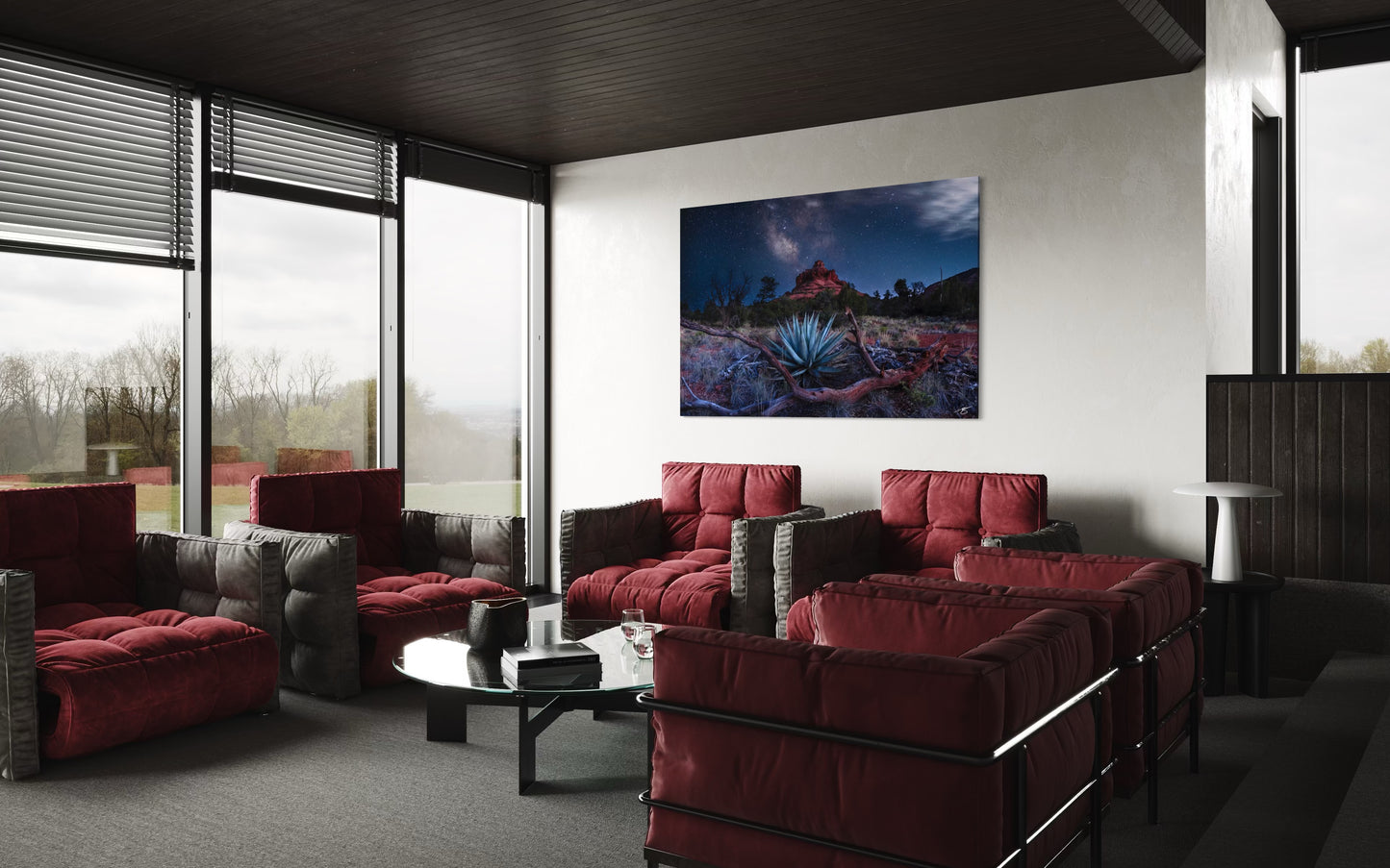 Modern living room with red sofas, a coffee table, and a large painting on the wall.