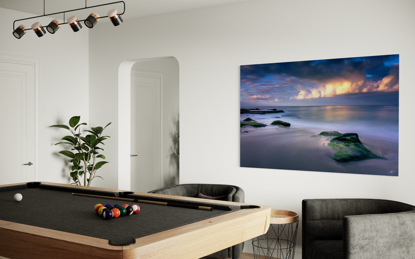 Minimalist long-exposure seascape with moss-covered rocks and soft ocean motion beneath dramatic coastal clouds.