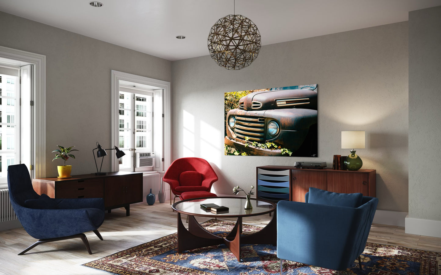 Modern living room with blue chairs, a red armchair, and a television displaying a car grille.