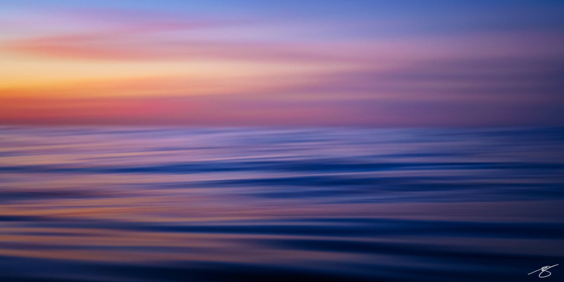 Abstract long-exposure photo of ocean waves at sunset with smooth blue and purple tones under a pastel sky, minimalist seascape panorama