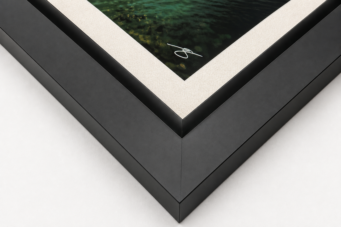 Close-up detail of a framed fine art print featuring a matte black gallery frame, oatmeal linen liner, and museum-quality craftsmanship.