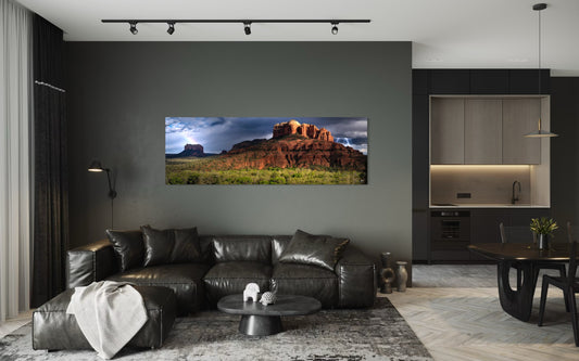 Modern living room with a large TV displaying a nature scene, leather sofa, and dining table.