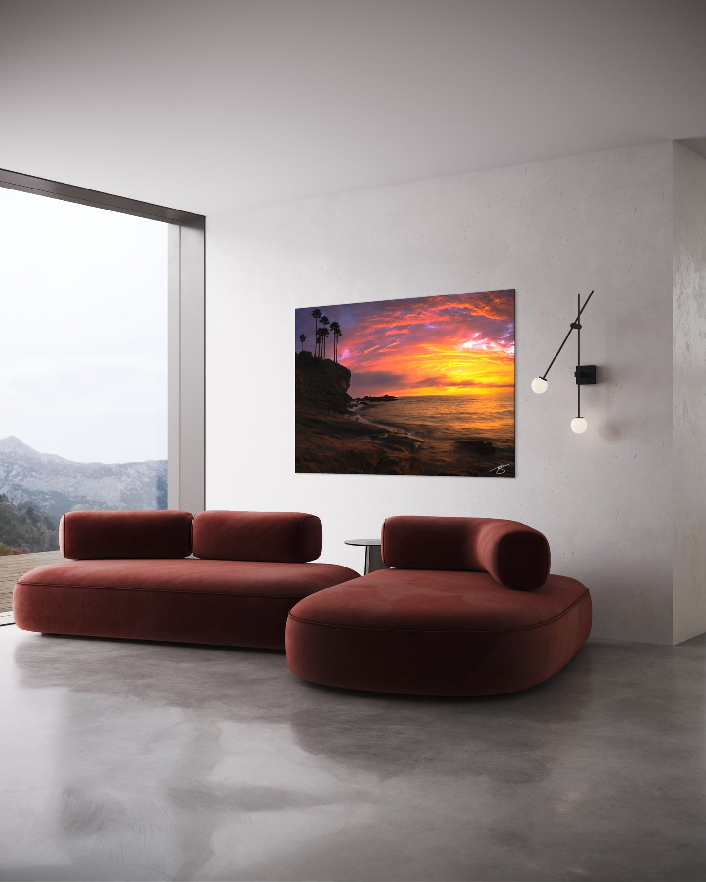 Modern living room with a red sofa and a sunset over water painting on the wall.