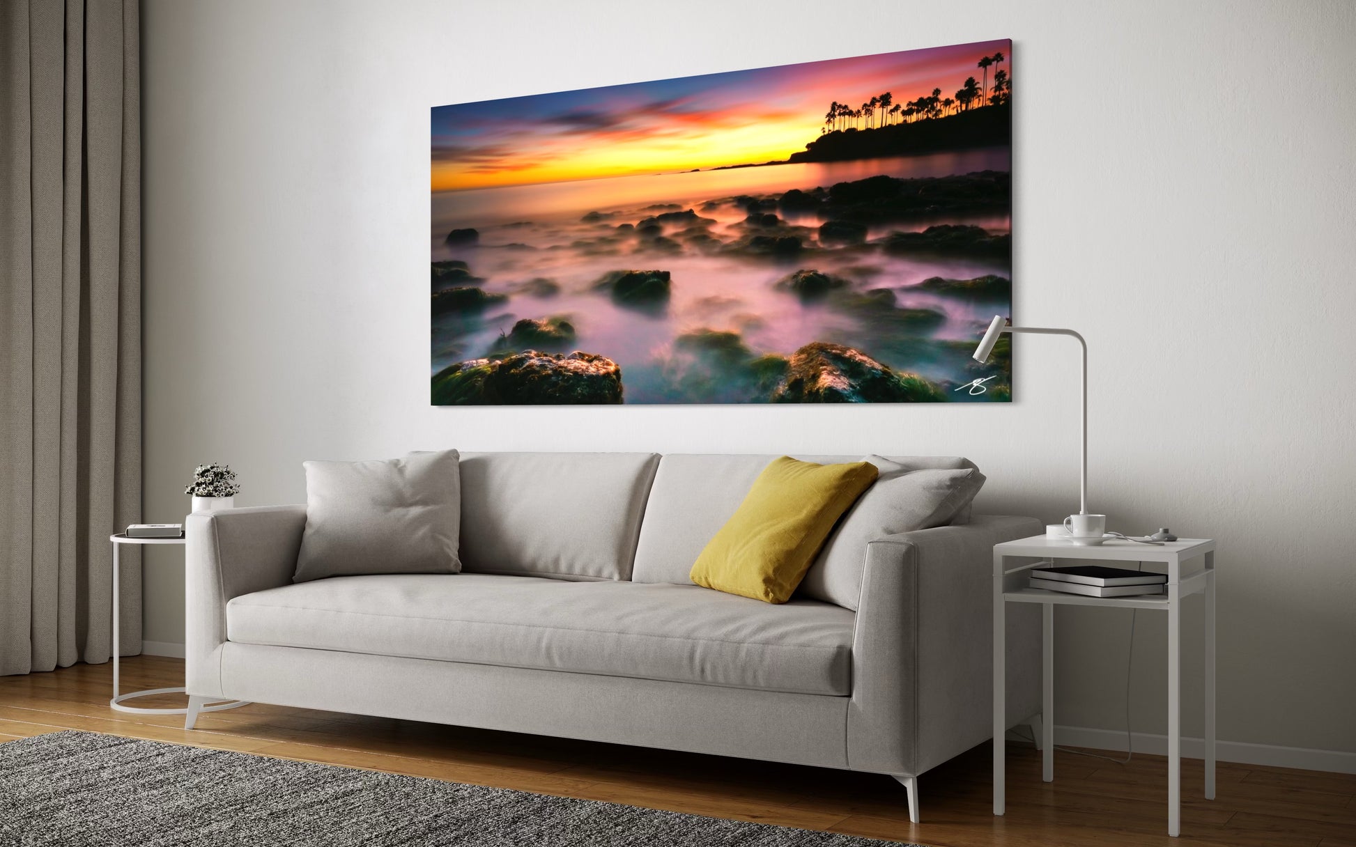 Living room with a large wall art depicting a sunset over water.