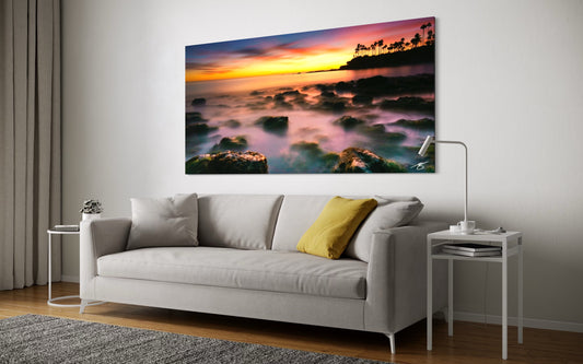 Living room with a large wall art depicting a sunset over water.