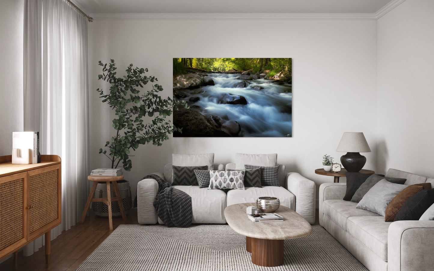 Living room with a large wall art of a river scene, gray sofa, and wooden coffee table.