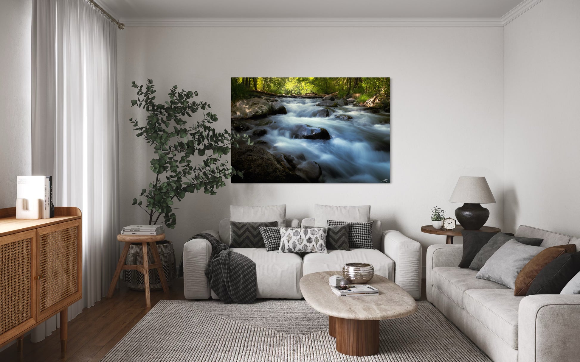 Living room with a large wall art of a river scene, gray sofa, and wooden coffee table.