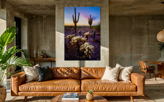 Living room with a brown leather sofa and a large desert landscape painting on the wall.