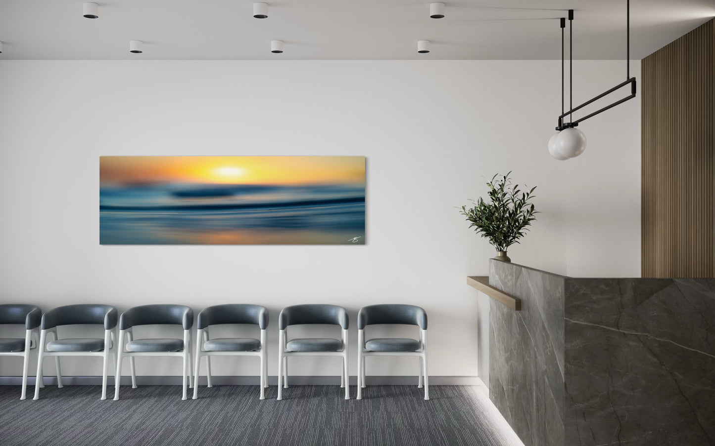 Modern office waiting area with a large wall art piece of a sunset over water.