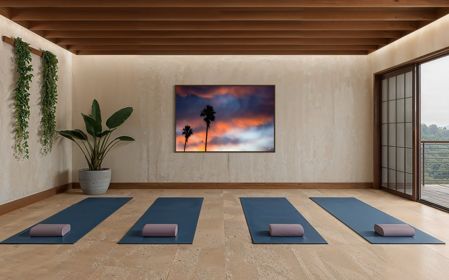 A vibrant California sunrise silhouettes tall palms and a lone bird in flight. A striking coastal sky captured in dramatic fine art detail.