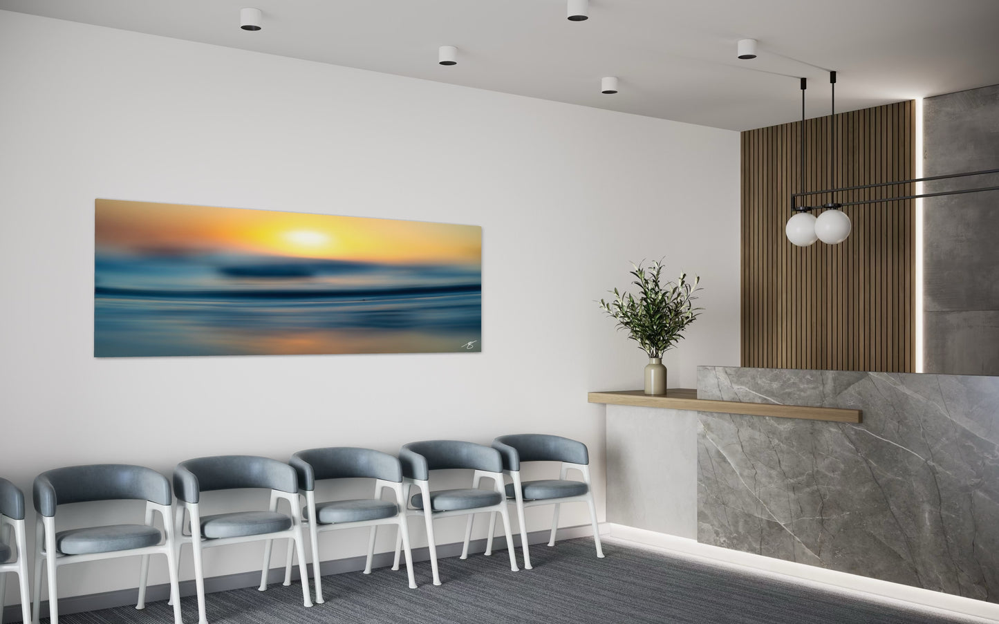 Modern waiting room with chairs, a reception desk, and a large abstract painting of a sunset.