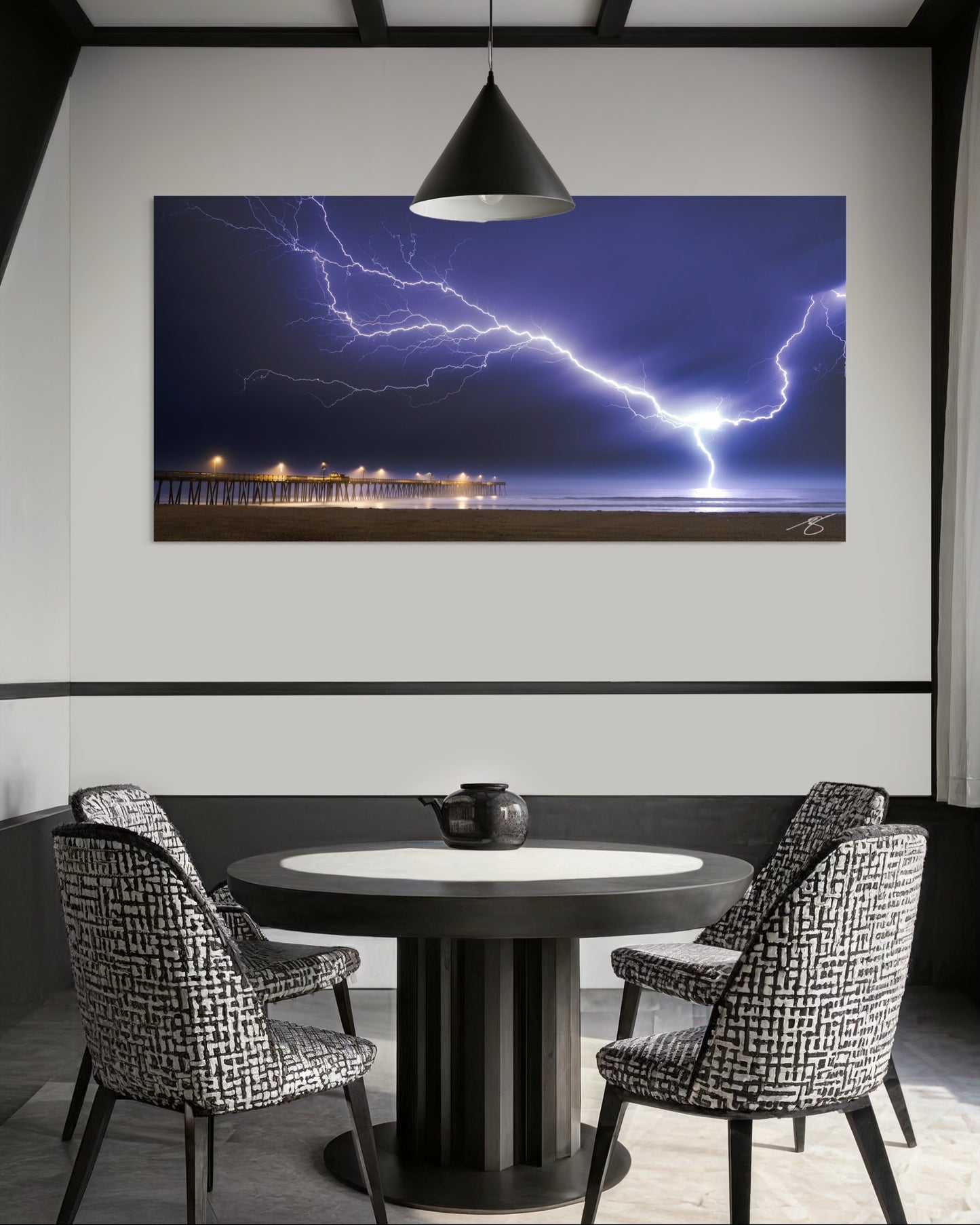 Dining room with a large TV screen displaying a lightning storm over a body of water.