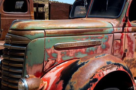 Fine art photograph of a rusted vintage General Motors truck with turquoise and red patina by Beau Jesse Johnston.