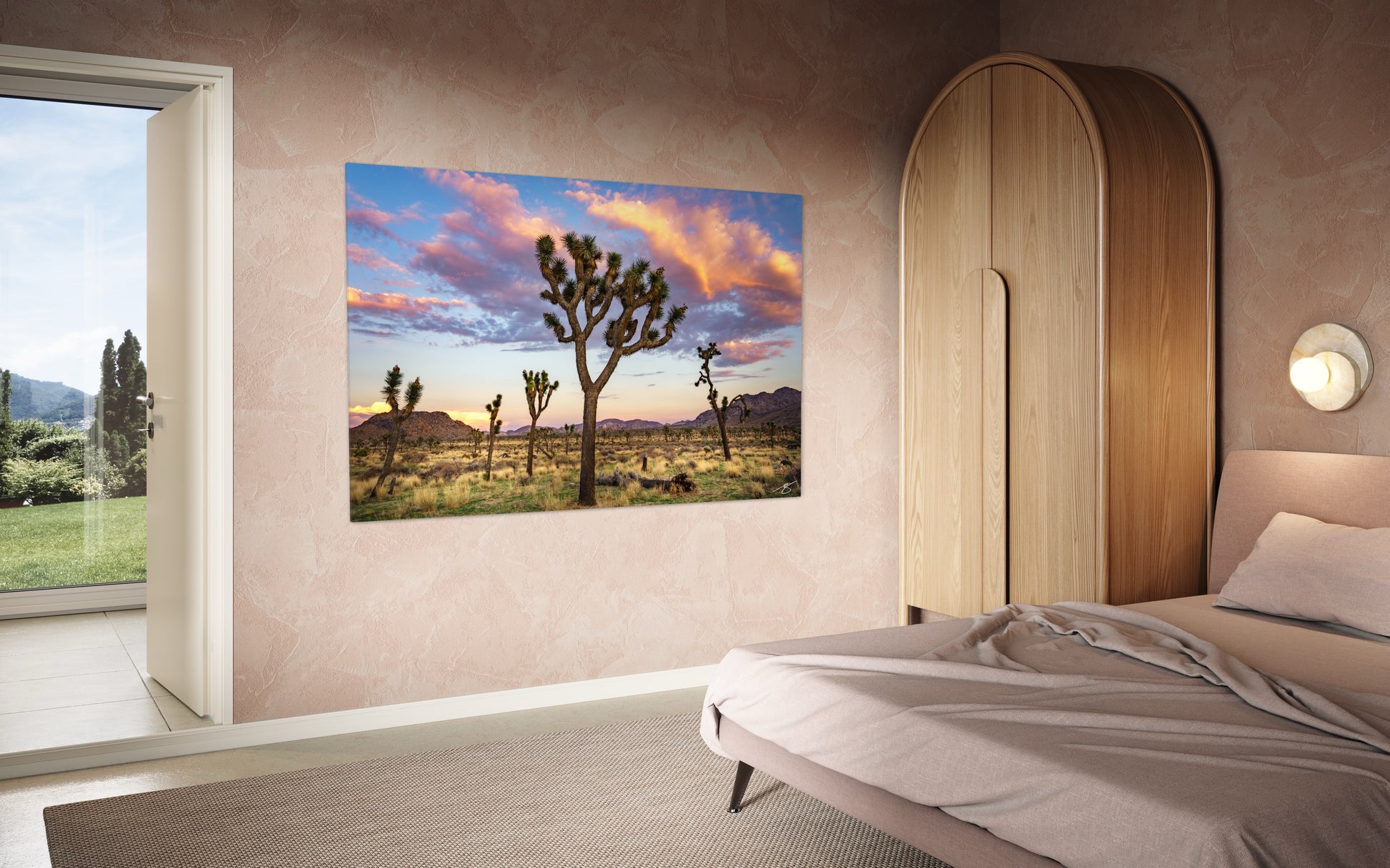 Joshua Tree National Park sunset with colorful pastel clouds and iconic Joshua trees in a golden desert landscape.