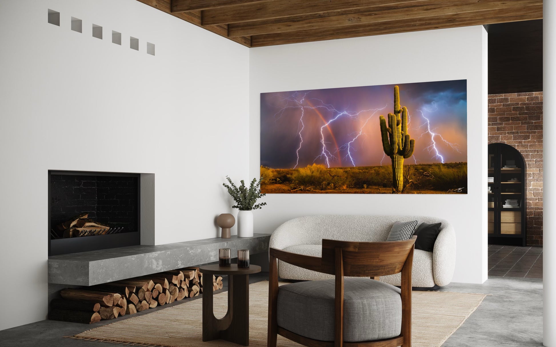Living room with a large wall-mounted TV displaying a desert scene with lightning.