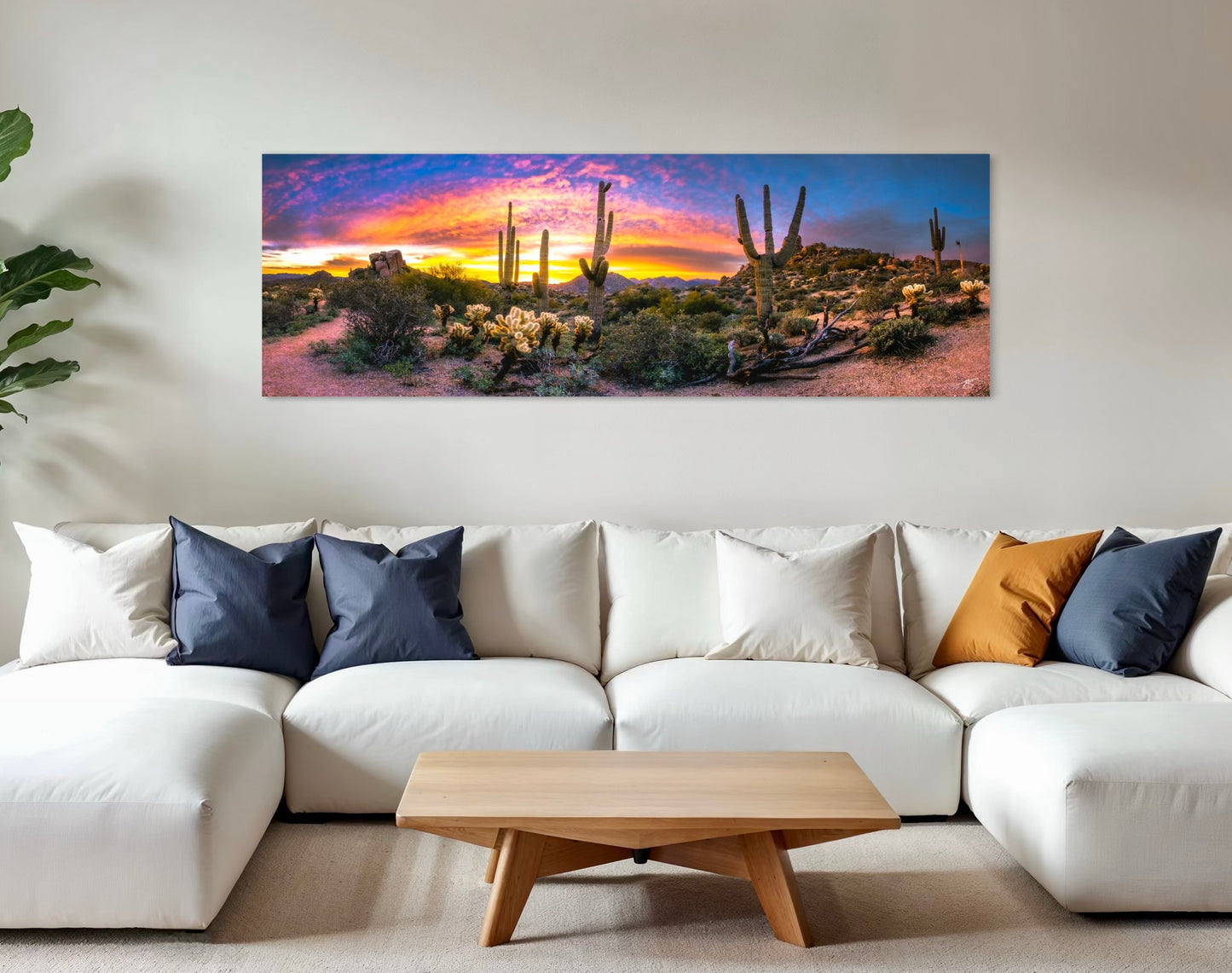 Panoramic sunrise over the Sonoran Desert with glowing saguaros, cholla, and a vibrant orange and magenta sky.