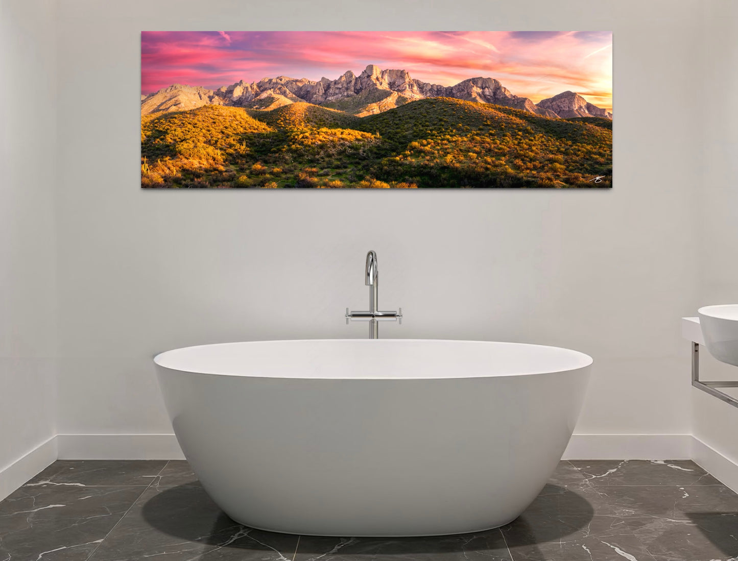 Panoramic sunset view of the Catalina Mountains in Tucson, Arizona with glowing desert hills and colorful clouds above.