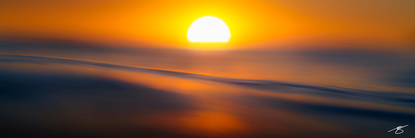 Abstract fine art ocean photo of sunset over water with golden light by Beau Jesse Johnston, minimalist seascape.
