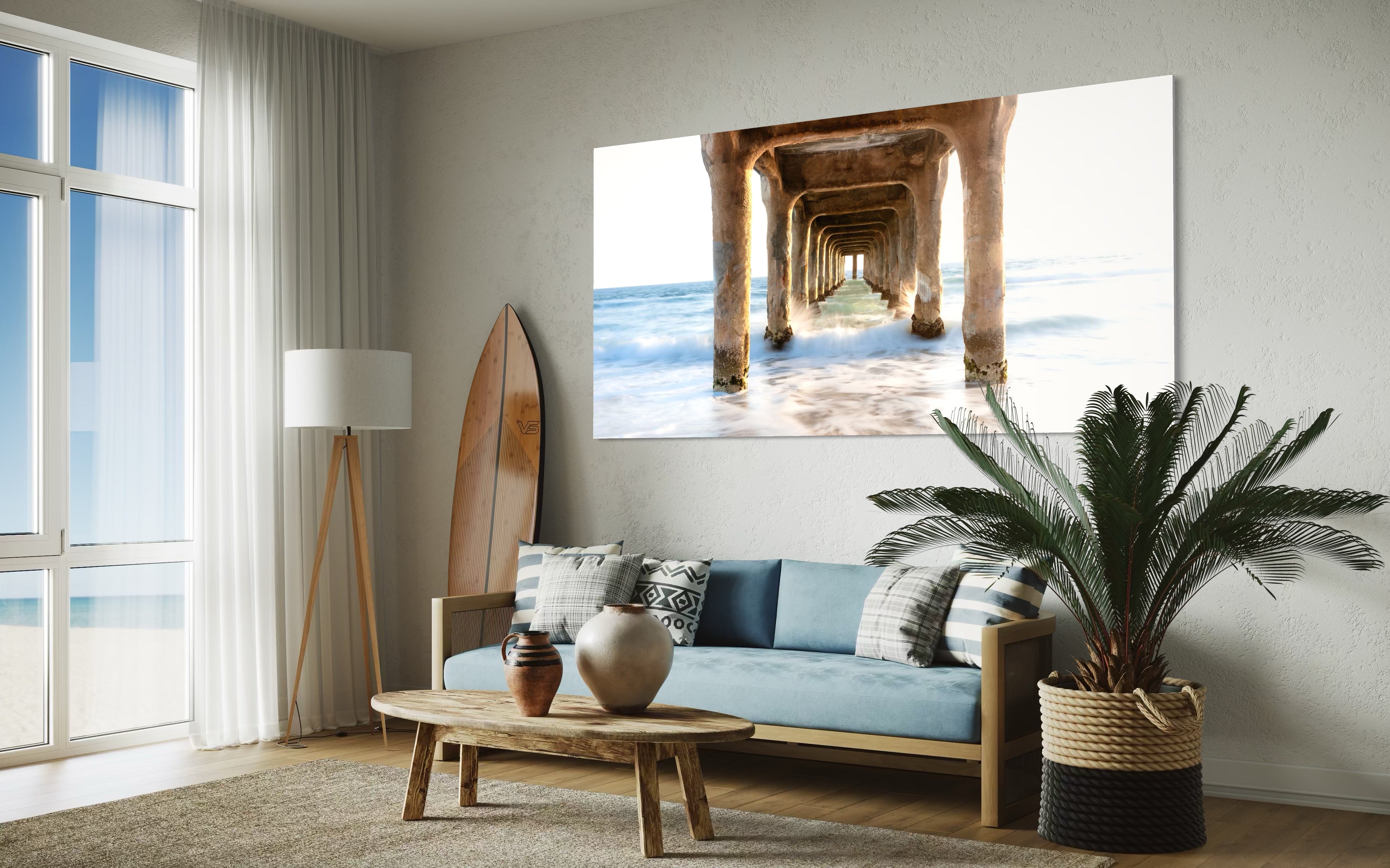Living room with a large wall art of a beach scene with a pier.
