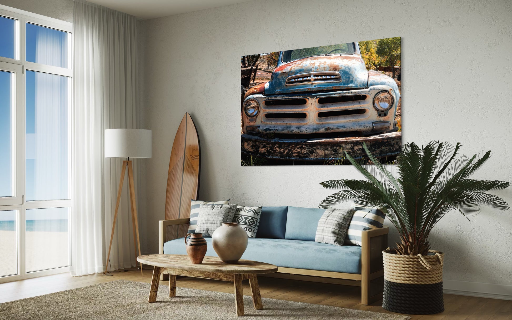 Living room with a couch, coffee table, and wall art of an old truck.