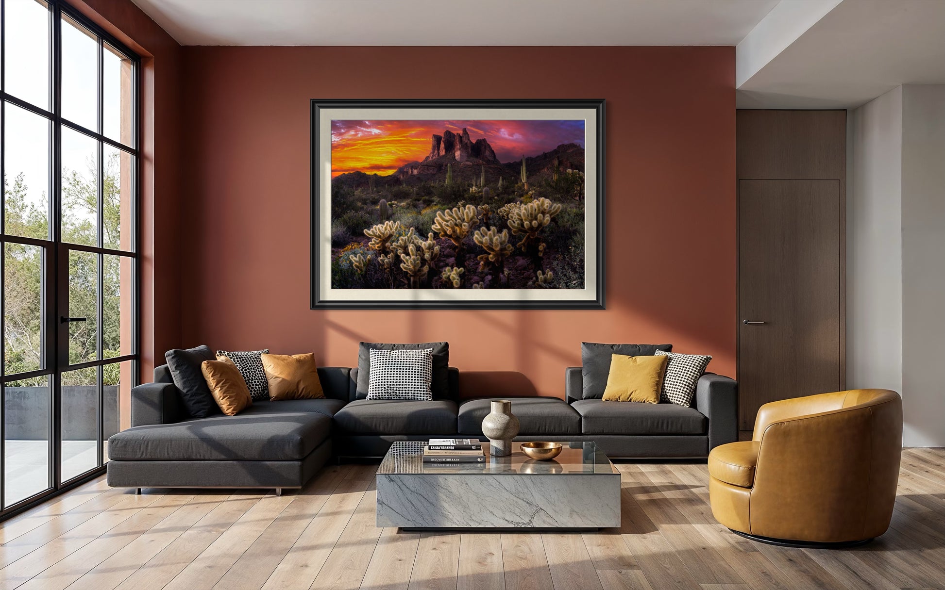 Desert Ablaze limited edition Arizona fine art photograph displayed in a black frame with linen liner above a modern living room sofa.