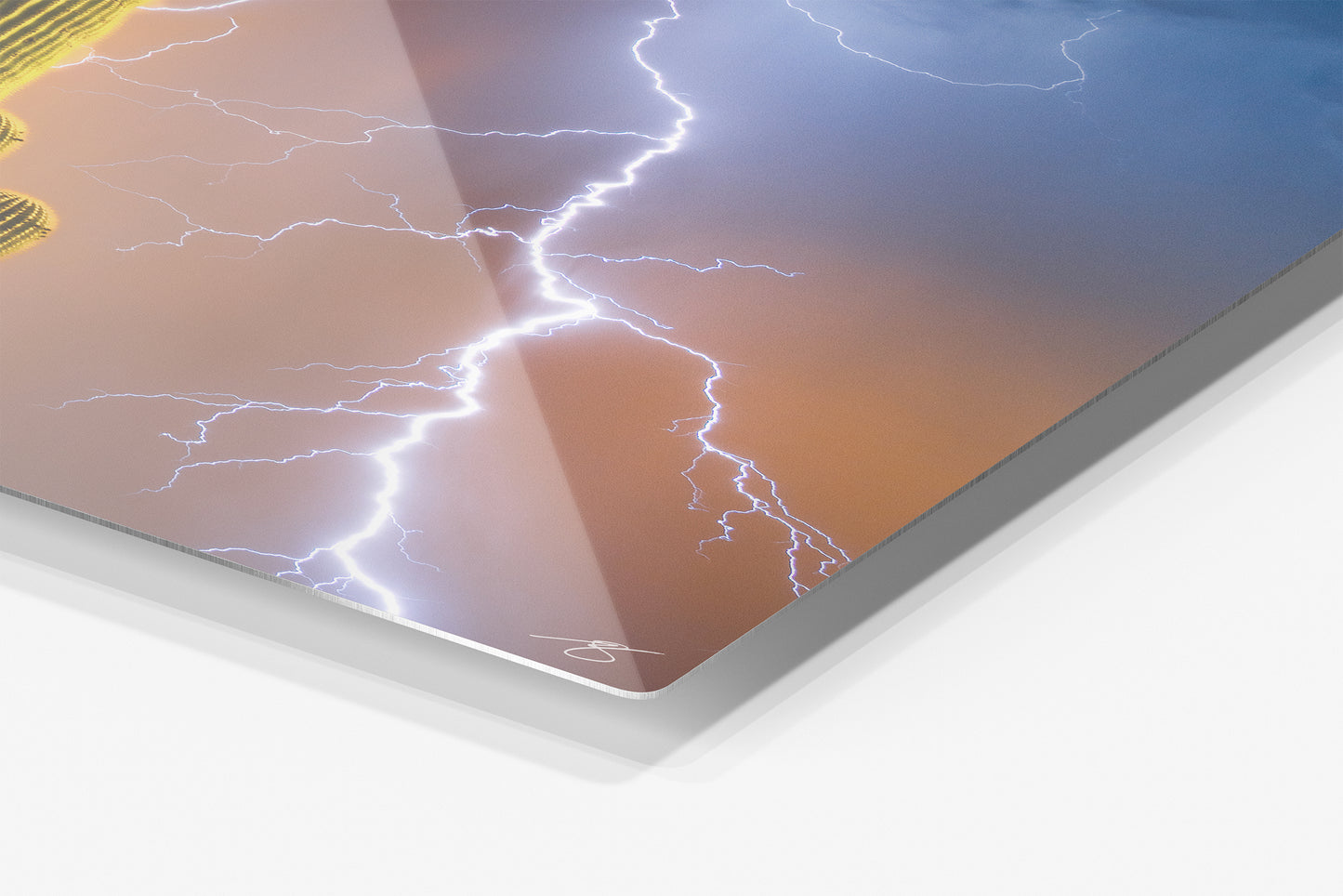 Close-up detail of the Desert Voltage aluminum print showing the glossy archival metal finish and rounded corner