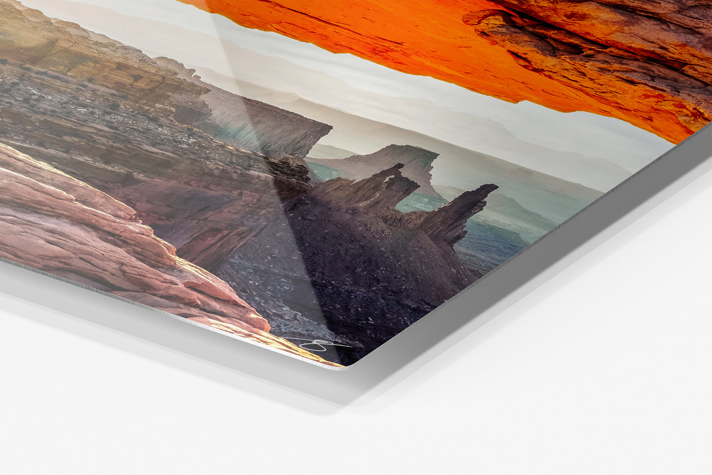 Close-up detail of the Mesa Rising aluminum print showing the glossy archival metal finish and rounded corner