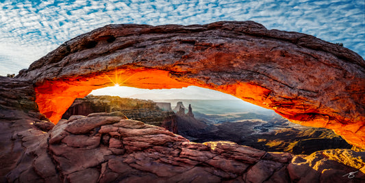 Mesa Arch illuminated by sunrise in Canyonlands National Park, Utah, overlooking the desert canyon landscape below