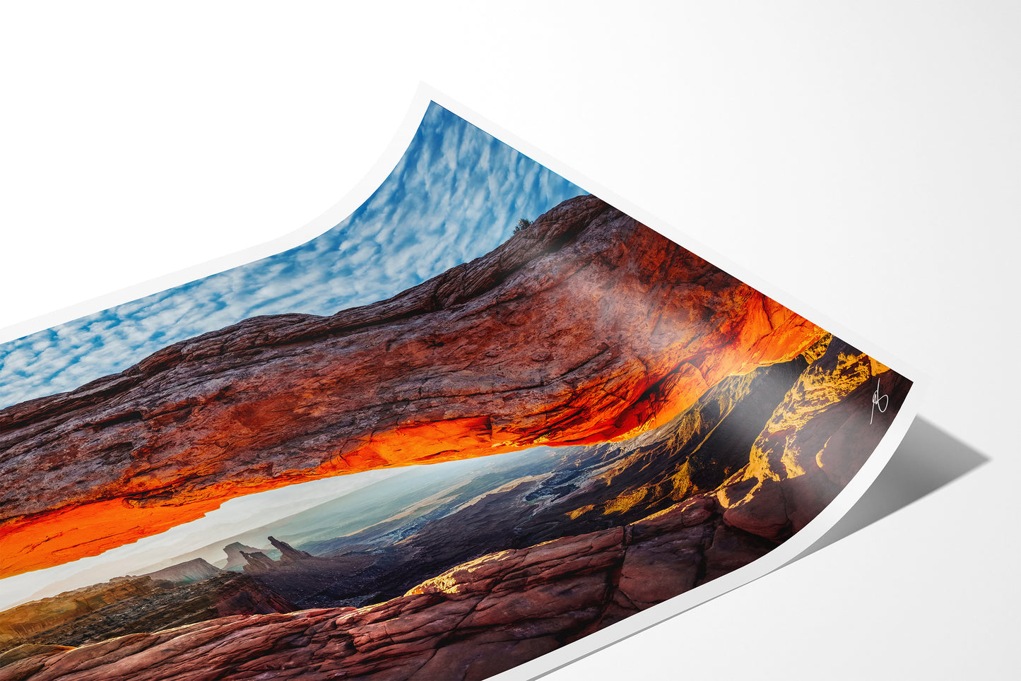 Close-up detail of the Mesa Rising fine art paper print showing the archival paper texture, white border, and curled paper corner.